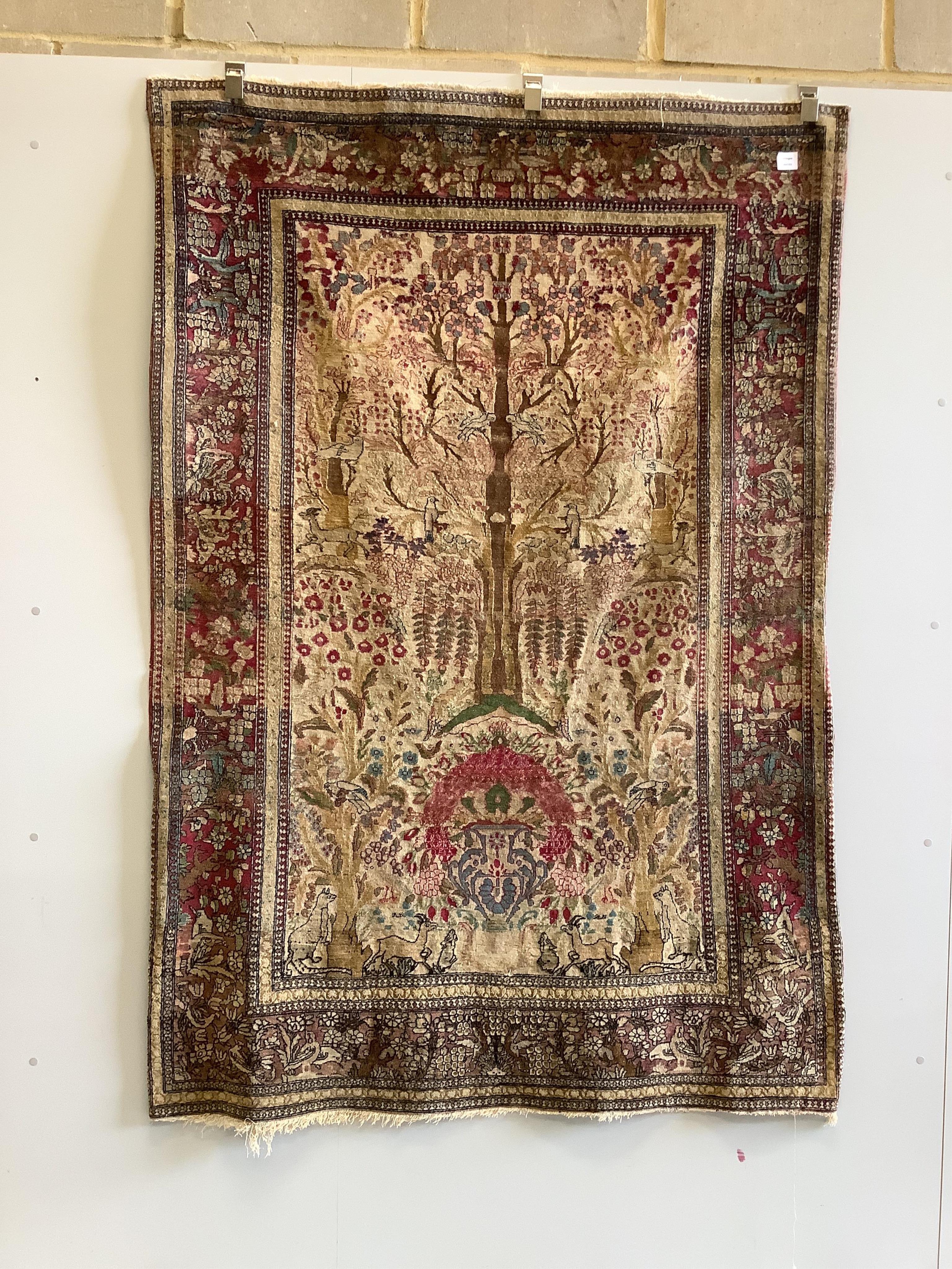 An antique Isphahan garden design ivory ground rug, approximately 200 x 130cm. Condition - fair